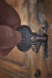 Close-up of human hand on door