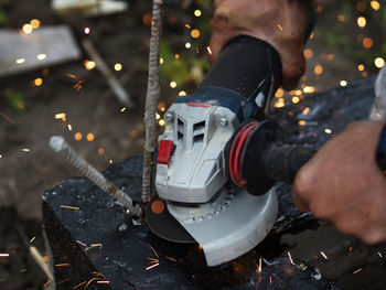 Low section of man working with toy