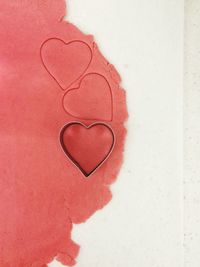 Close-up of heart shape on red wall