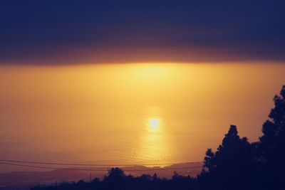 Scenic view of sea against romantic sky at sunset