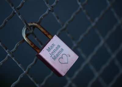 Close-up of padlock on chainlink fence