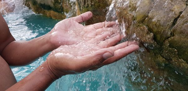 High angle view of hands in water