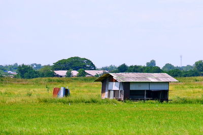 House on field against clear sky