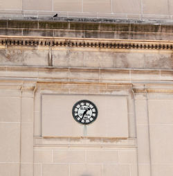 Low angle view of clock on wall