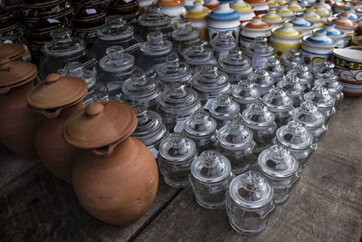 High angle view of glasses in jar on table