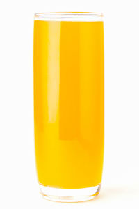 Close-up of yellow glass against white background