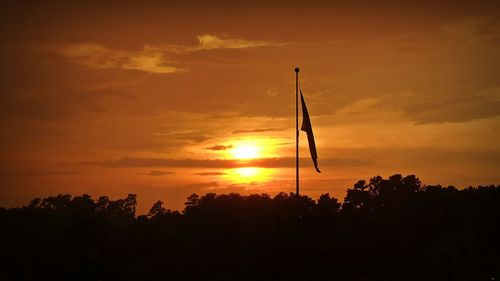 Silhouette trees against sky during sunset