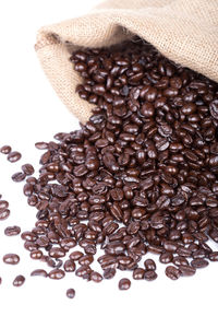 High angle view of coffee beans on white background