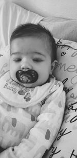 Portrait of cute boy lying on bed