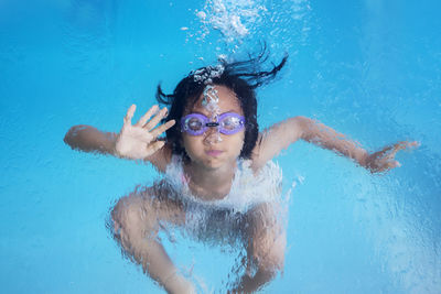 Portrait of cute girl swimming in pool