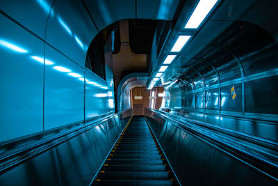 Low angle view of illuminated tunnel at subway station
