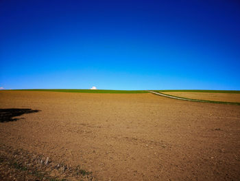 Scenic view of landscape against clear blue sky