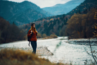 Full length of woman standing on mountain