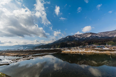 Scenic view of lake and mountains against sky