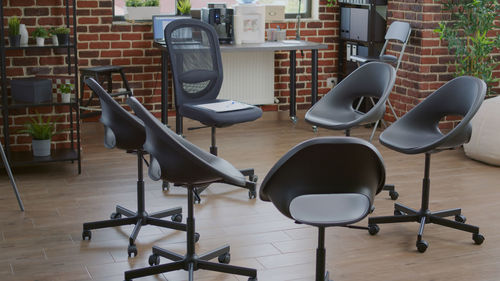 Empty chairs and tables on hardwood floor at home