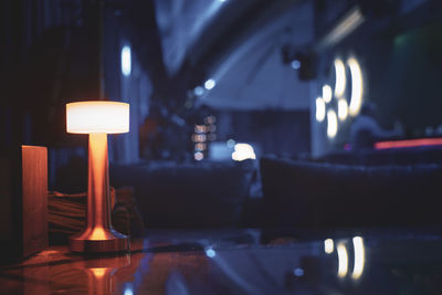A table lamp lighting up the table at a bar in yerevan