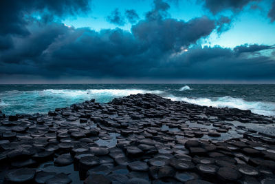 Scenic view of sea against cloudy sky