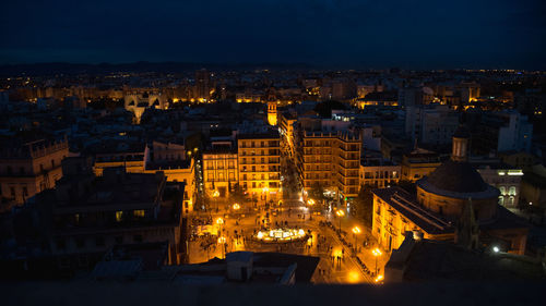 High angle view of illuminated buildings in city at night