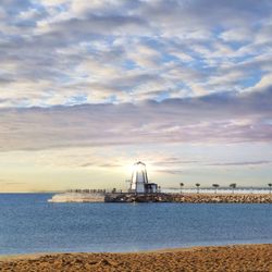 Scenic view of sea against cloudy sky