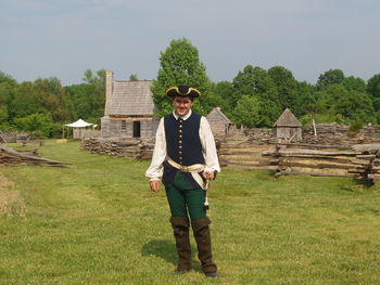 Portrait of boy wearing costume while standing on field