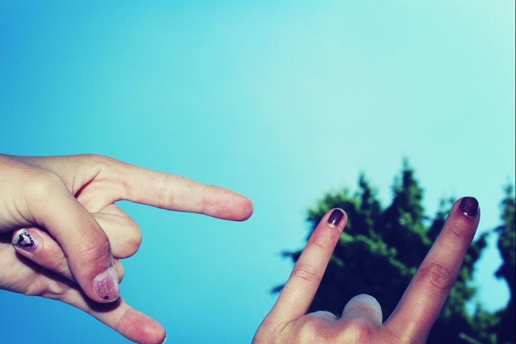 person, part of, human finger, holding, cropped, copy space, personal perspective, close-up, clear sky, unrecognizable person, studio shot, blue, showing, white background, lifestyles, nail polish, focus on foreground