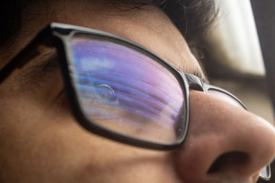 Close-up of man using glasses