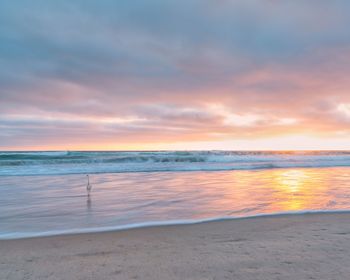 Scenic view of beach against sky during sunset