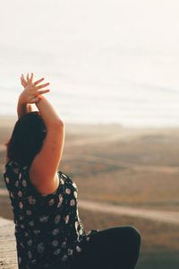 Woman exercising on landscape