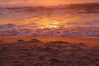 Scenic view of beach against sky during sunset