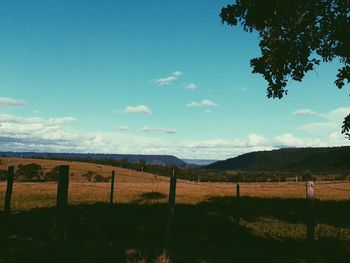 Scenic view of landscape against cloudy sky