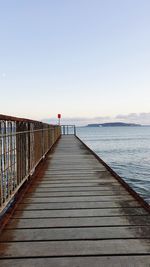 Pier over sea against clear sky