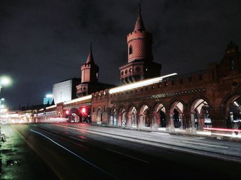 Light trails on bridge in city at night