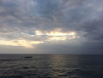 Scenic view of sea against cloudy sky