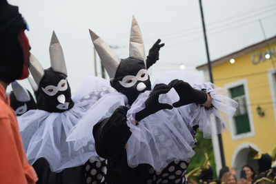 People dressed in different styles are seen having fun during the carnival 