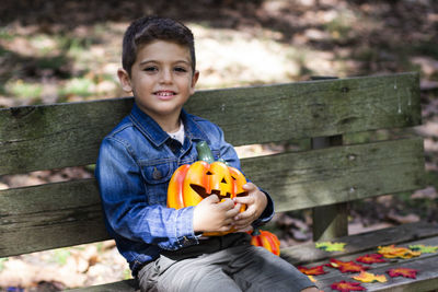 Portrait of smiling boy holding jack o lantern