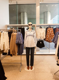 Woman standing in rack at store