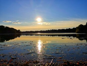 Scenic view of lake against sky during sunset