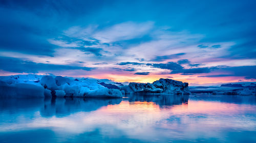 Scenic view of lake against sky during sunset