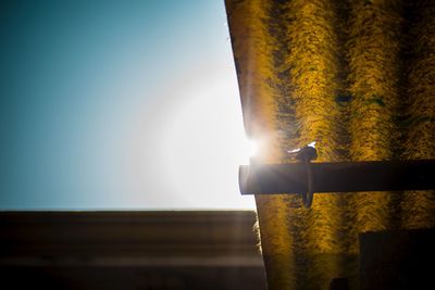 Low angle view of illuminated window against bright sun
