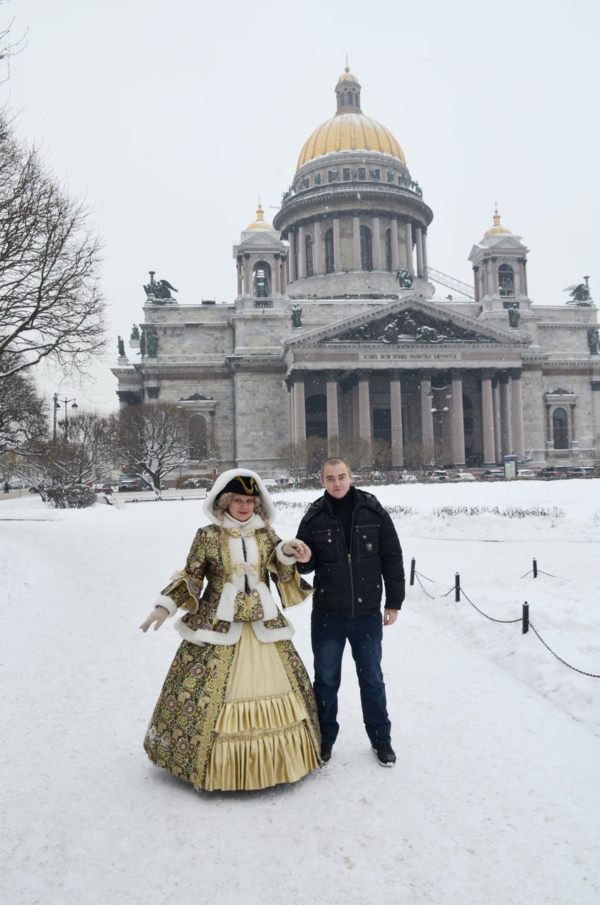 building exterior, winter, snow, architecture, lifestyles, cold temperature, leisure activity, built structure, clear sky, men, tourist, tourism, person, famous place, season, travel destinations, walking, full length, incidental people