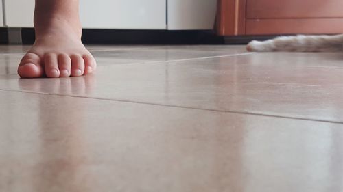 Low section of child on floor at home