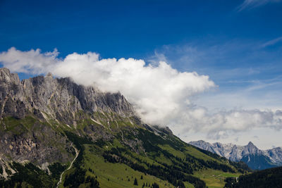 Scenic view of mountains against cloudy sky