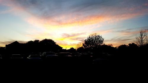 Cars on road at sunset