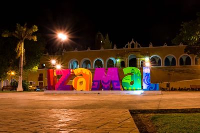 Illuminated building against sky at night