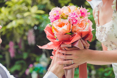 Bouquet in the hands of the groom. to make a happy wedding gift to a young bride.