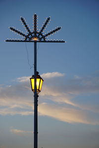 Low angle view of windmill against sky