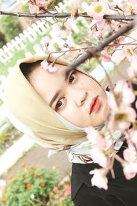 Portrait of girl with pink flower