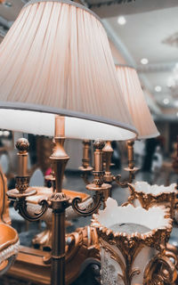 Close-up of electric lamp hanging from ceiling