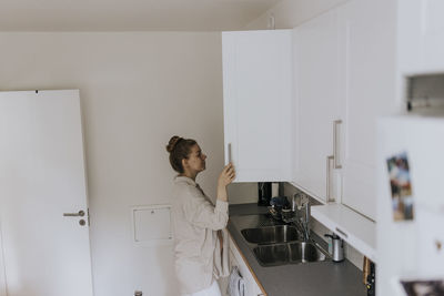 Woman standing in kitchen