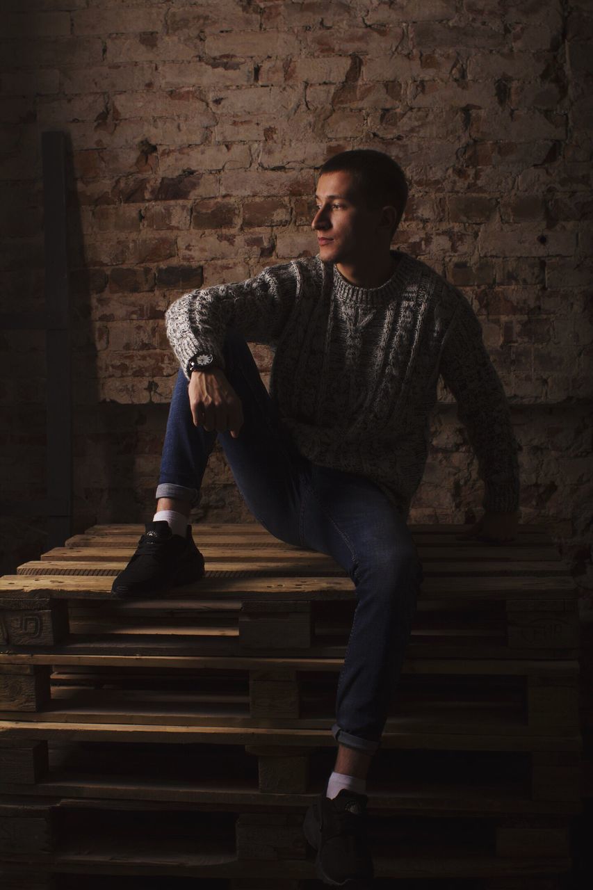 MAN SITTING ON BENCH AT NIGHT